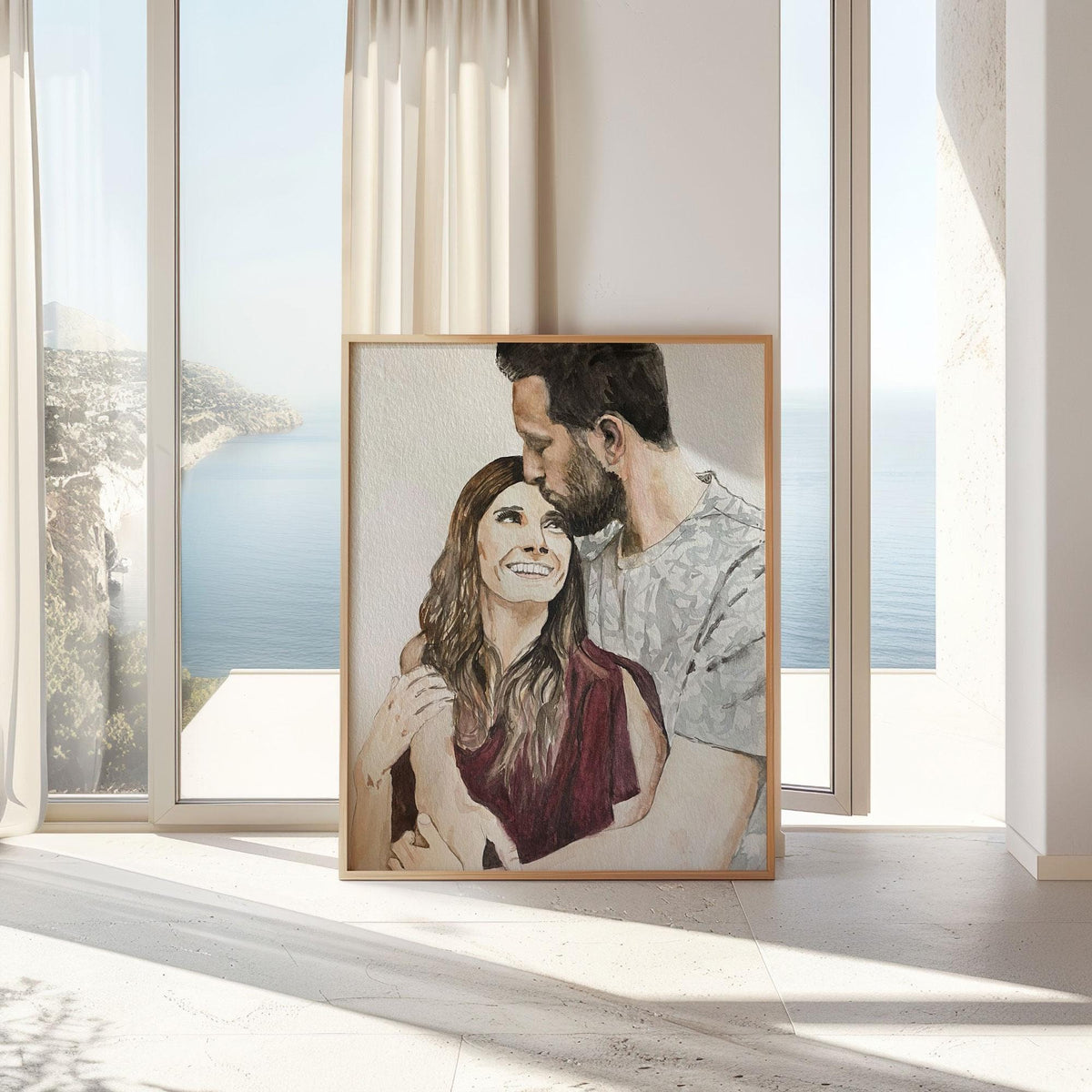 Framed watercolour couple portrait from a photo, leaning by a tall window with a sea view