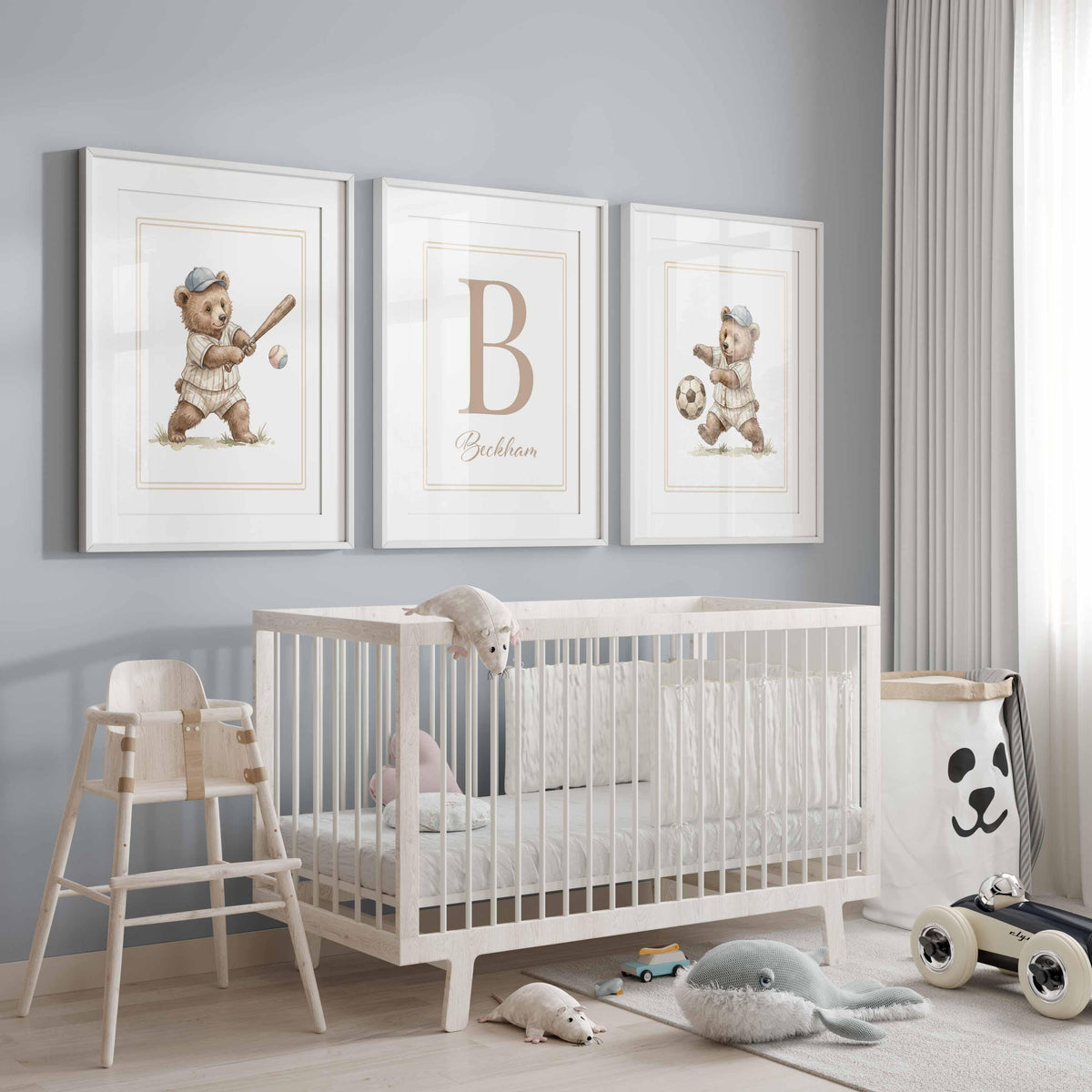 Teddy bears playing ball either side of a letter B above a crib