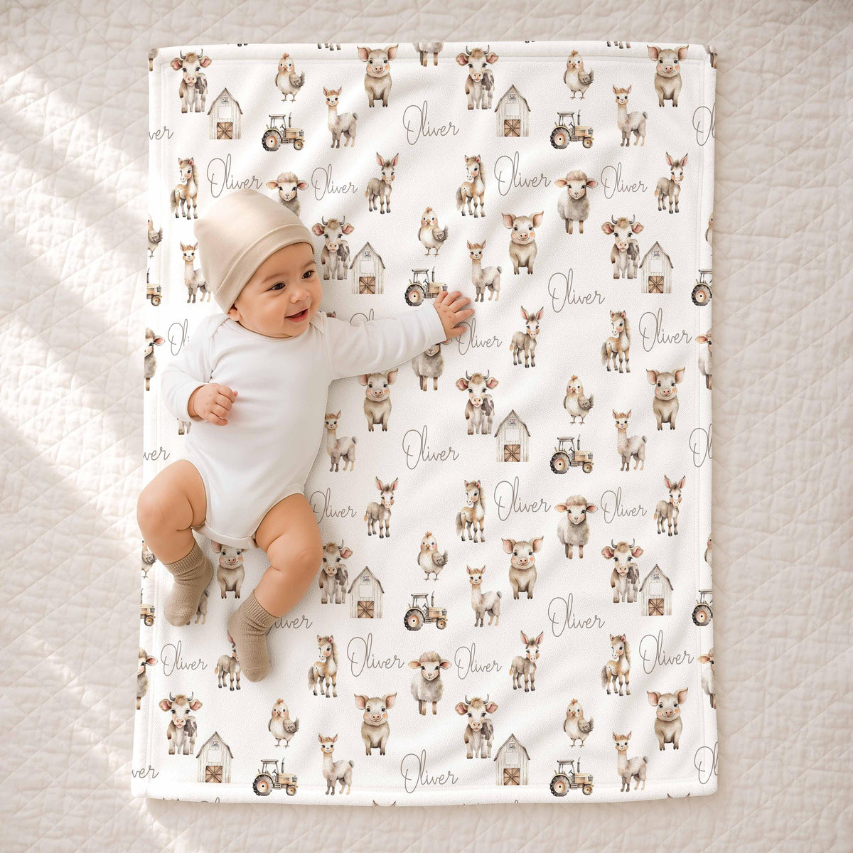 Baby lying on the farm animal blanket