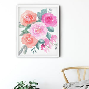 Pink and coral roses in a white frame above a wooden chair