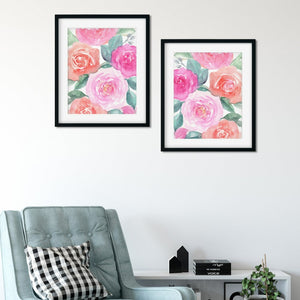 Two pink rose pattern prints in black frames above an armchair