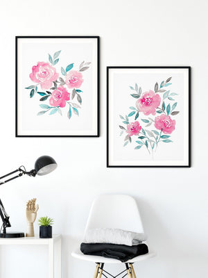 Two pink rose posy prints above a desk and white chair